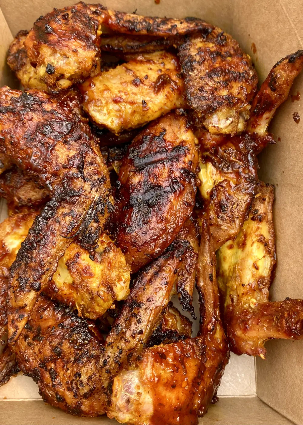 Chicken charred and glazed in hot sauce