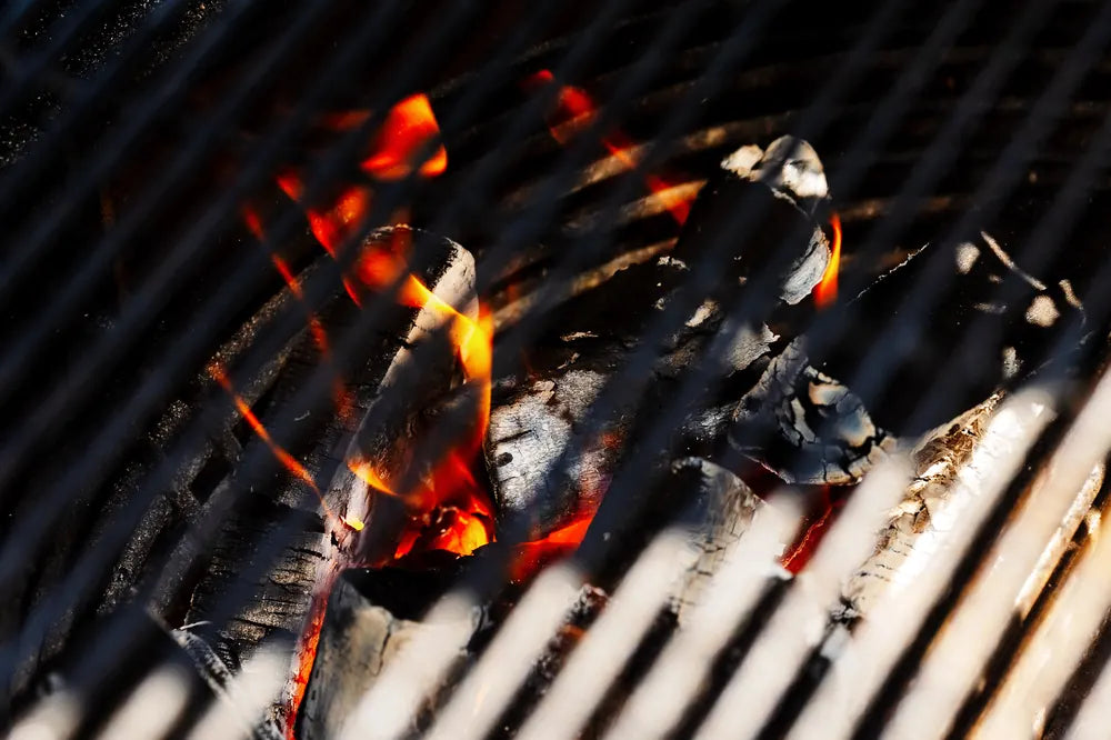 Embers glowing under a grill