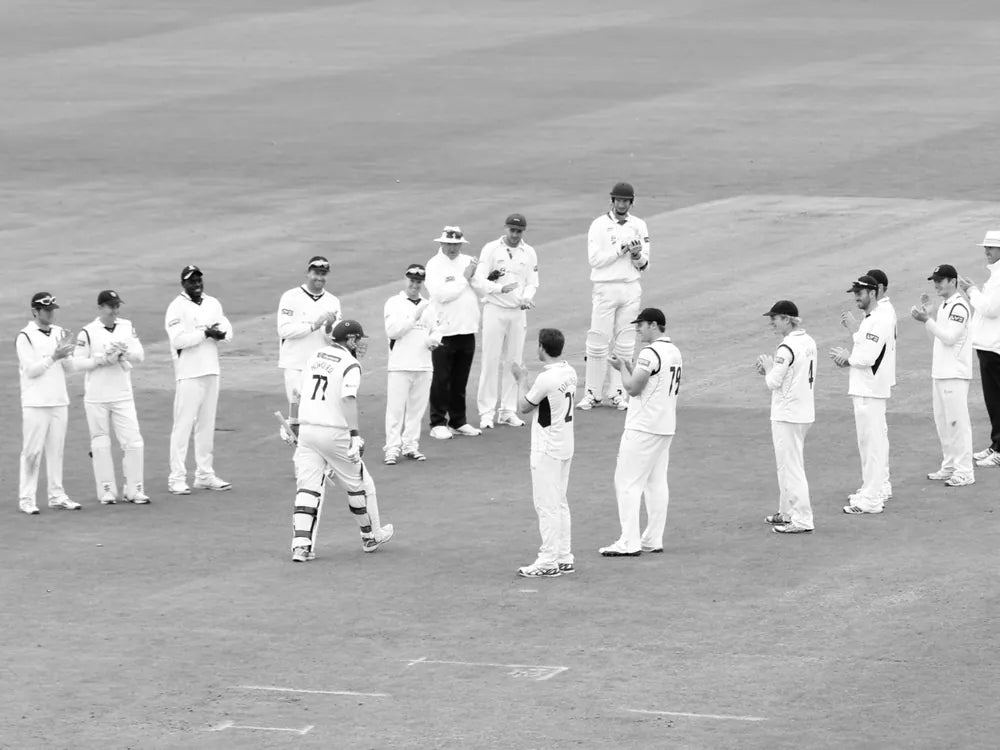 Players applaud Hoggy onto the field in his last match