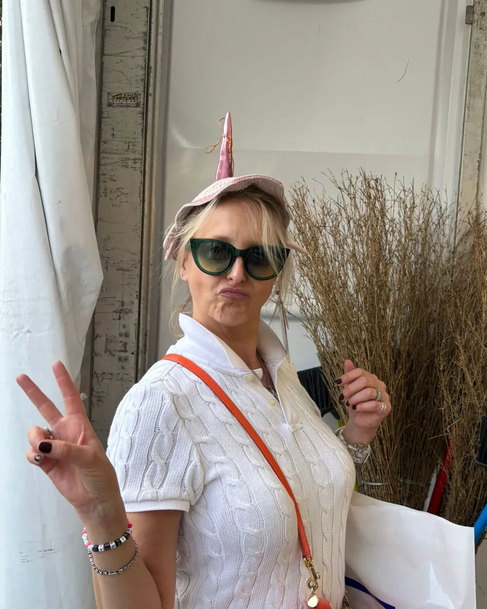 Sarah in a unicorn-horn hat and sunglasses